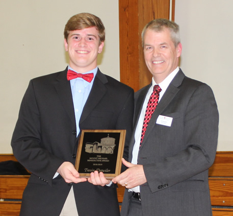 Dr. Peters presents Trevin Detwiler with the Mount Michael Award