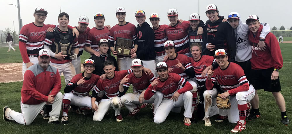 Joyous Knights celebrate the B-1 District Championship with a rain streaked team photo
