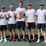 Photo of team with medals and championship plaque